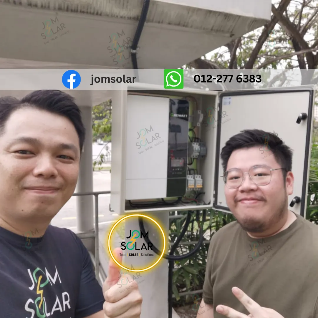Two Jomsolar team members beside an open outdoor equipment cabinet