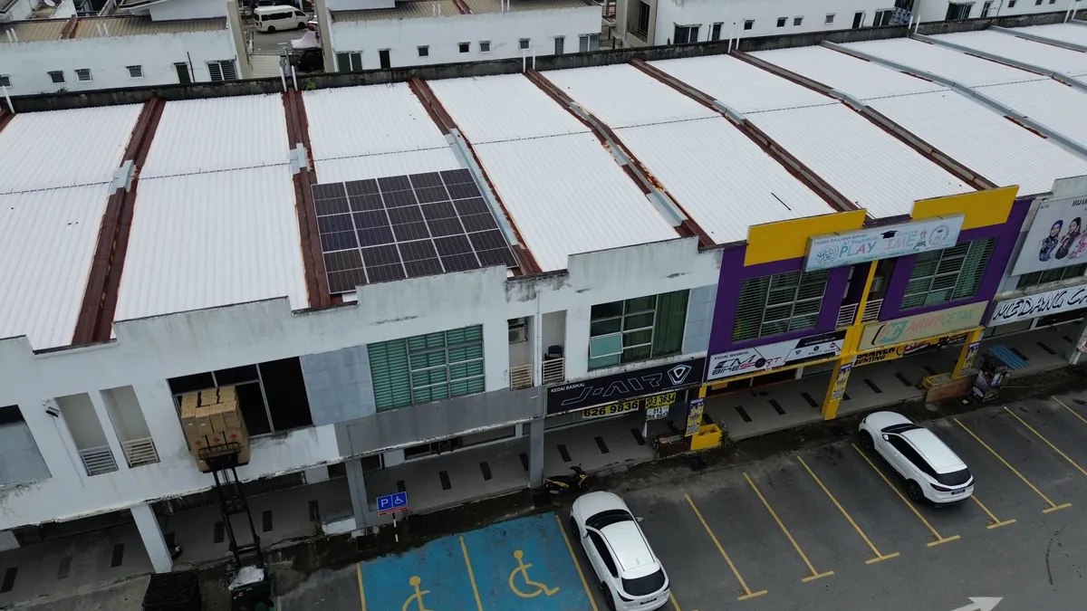 Aerial view of solar panels on the roof of a shop-lot row