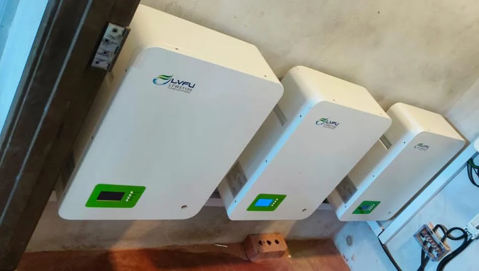 Three wall-mounted lithium battery units with display screens
