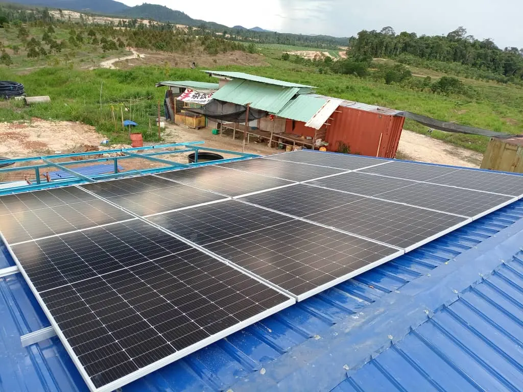 Solar array on a blue metal roof at a riverside site