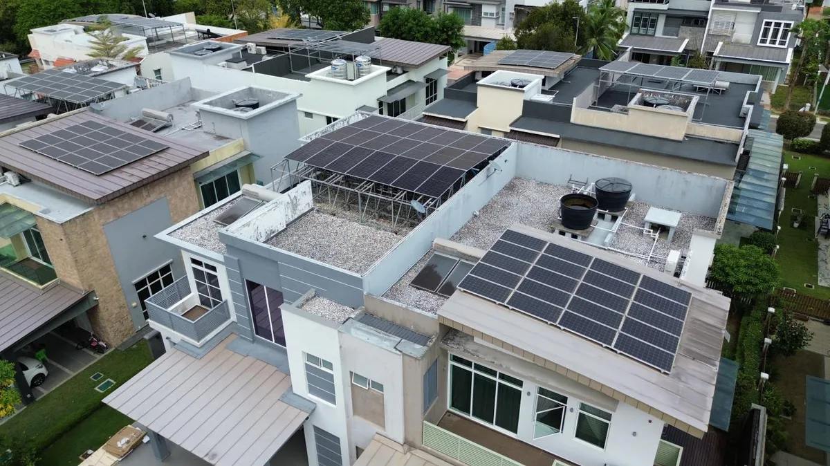 Aerial view of rooftop solar arrays on modern terrace houses