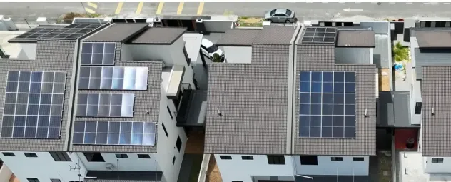 Aerial view of rooftop solar arrays on a row of terraced houses