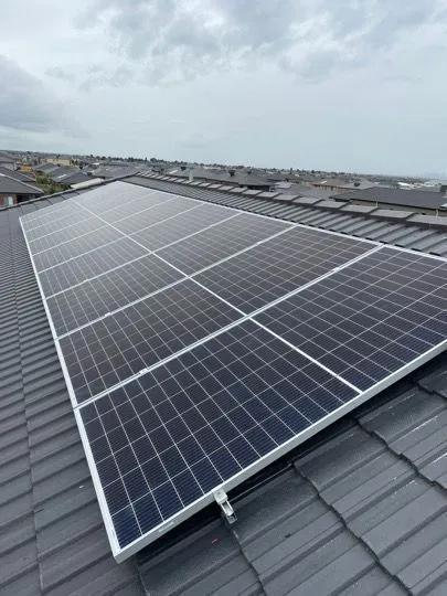 Illustration: a solar array on a dark tiled house roof